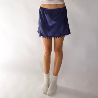 Young woman wearing the navy short version of the STOW Apparel Gemini Skirt.