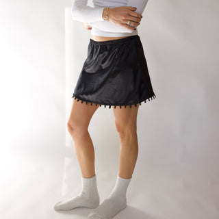 Young woman wearing the short black version of the STOW Apparel Gemini Skirt.